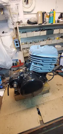 Finished vintage two-stroke engine with a freshly painted finned cylinder