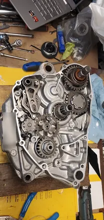 Four-stroke engine case half with the clutch-side gears and shift mechanism