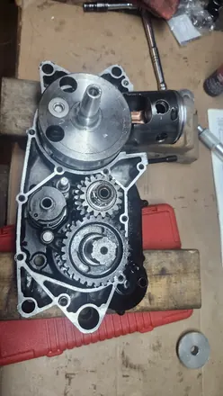 Vintage two-stroke case half with the crankshaft and piston