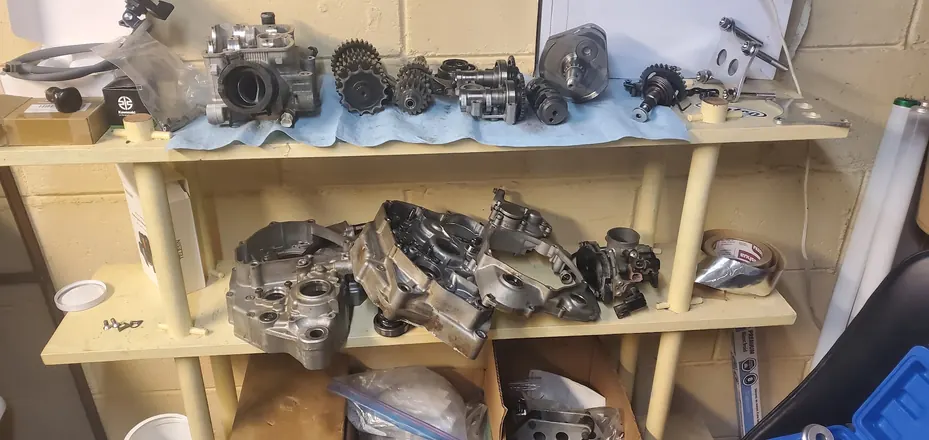 Engine parts organized on a shelf during a full teardown