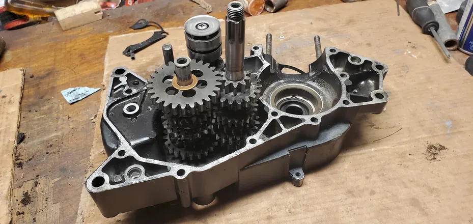 Vintage two-stroke case half with the transmission gear stack installed
