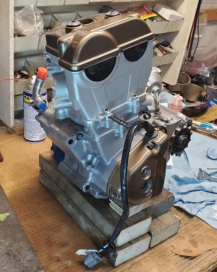 A 4-stroke dirt bike engine on the workbench in our home shop